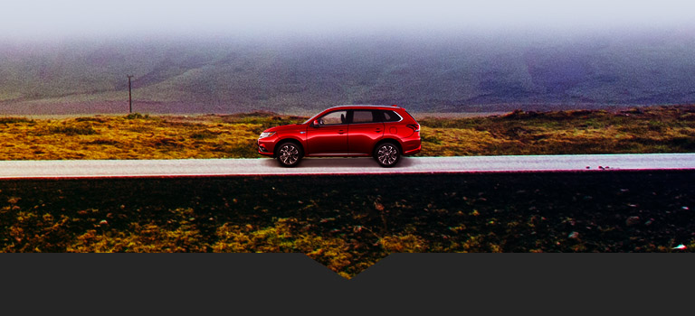2018 Mitsubishi Outlander PHEV driving on a misty road
